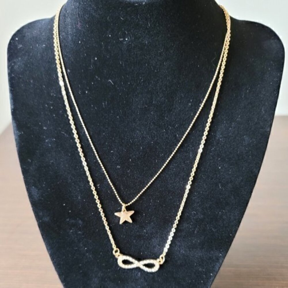 Golden and rhinestone multi-strand necklace with infinity symbol and sta…